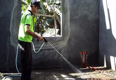 Technician Spraying Termite Soil Posioning
